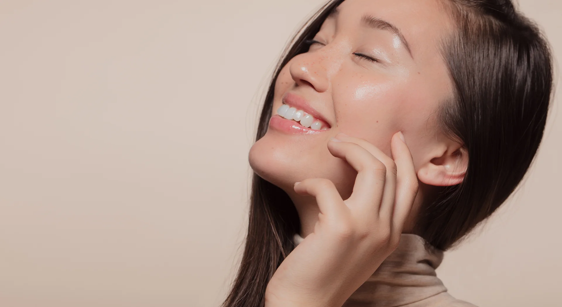a smiling woman touching her smooth skin